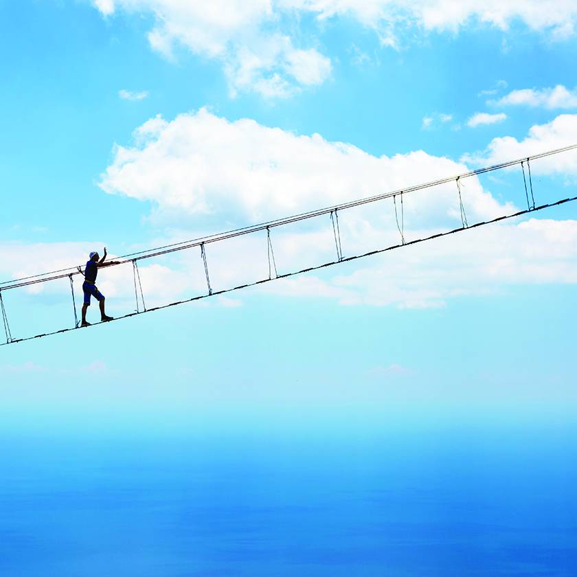 Person walking across a bridge