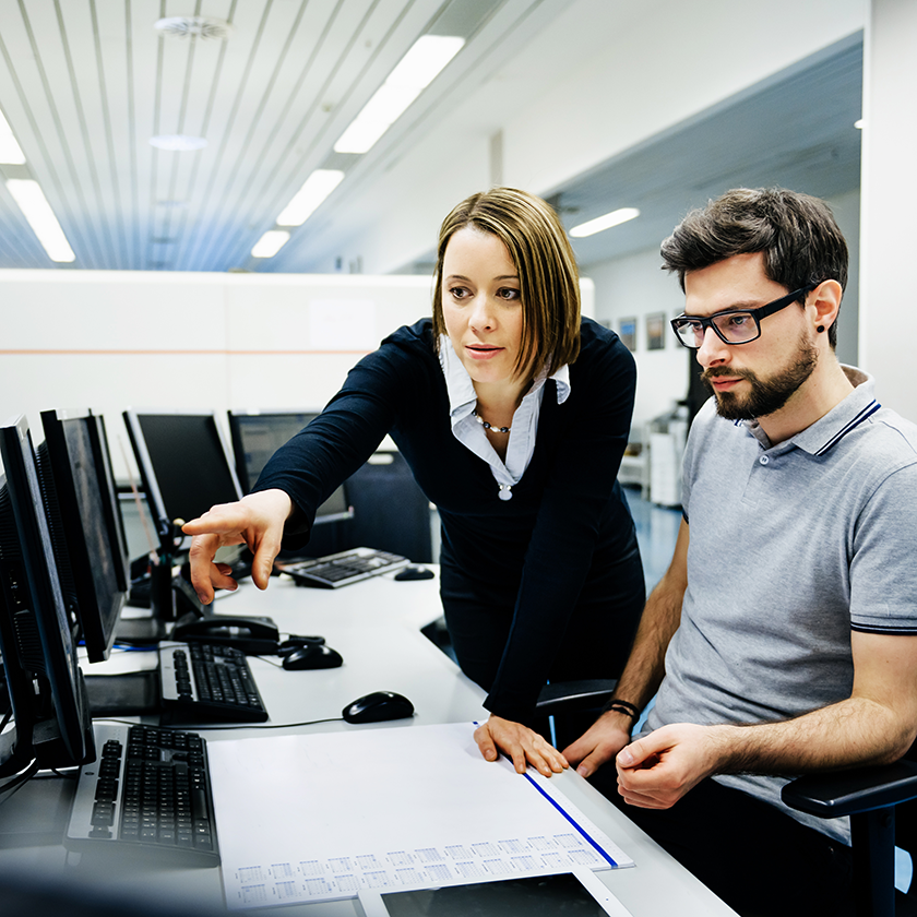 Two IT professionals in a control room