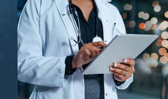 Doctor looking at iPad