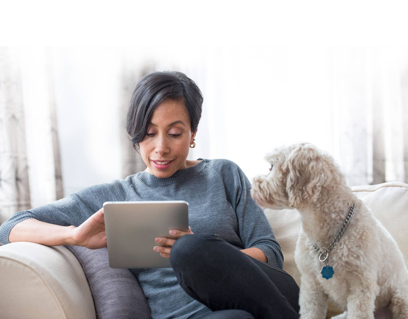 Woman with tablet and dog